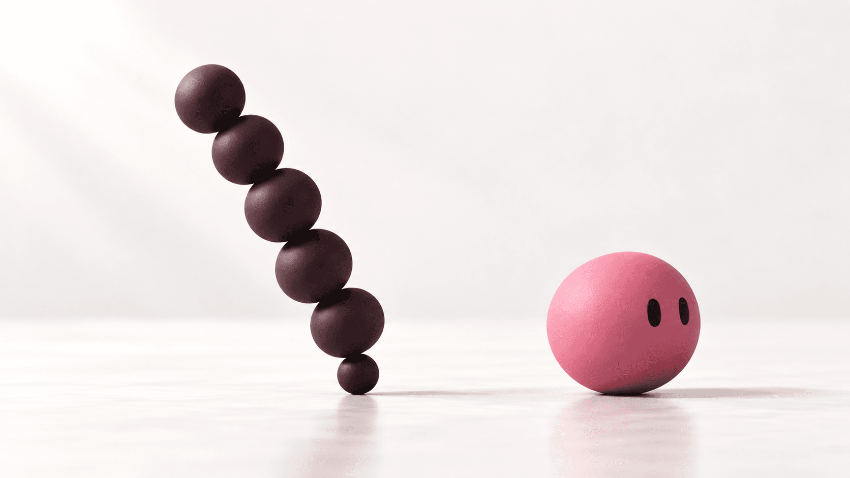 La esfera rosa con ojos mira una torre inclinada de esferas